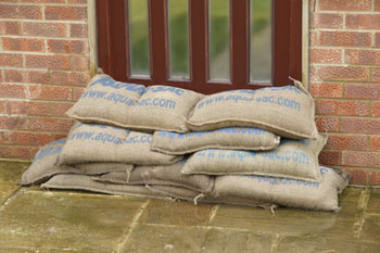 Self Filling sandbags wet and protecting a front door